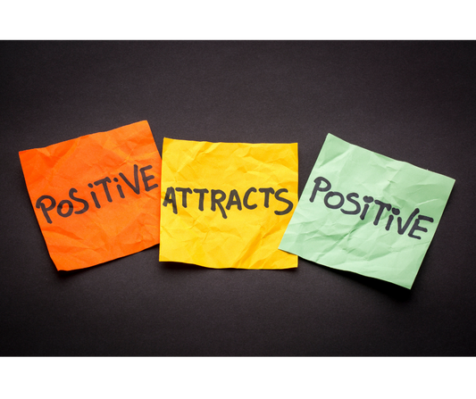 Coloured post it notes that say positive attracts positive